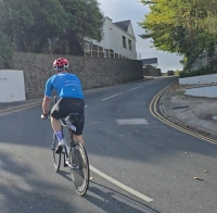 Cyclist climbing a West Wales hill